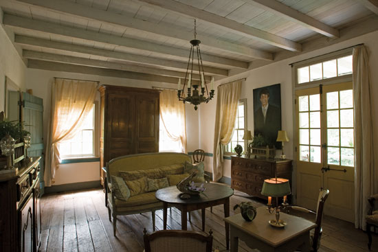 Madeleine Cenac and her crew lovingly restored the original parlor of this 19th-century cottage. The wood floor and ceiling are original, the plaster walls were authentically replicated, and the color scheme is true to the original.